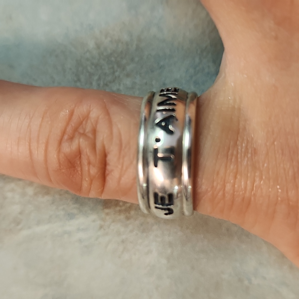 Carolee sterling ring size 4.5 says Je T'aime (and) I love you.